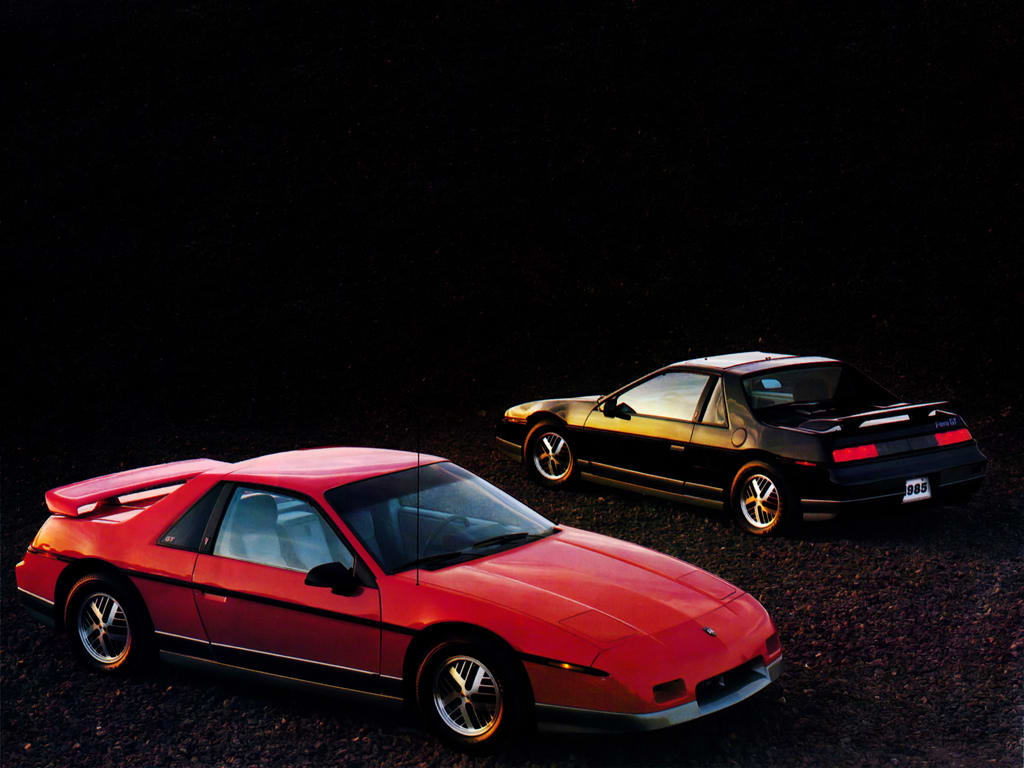 Deux Pontiac Fiero, une rouge et une noire